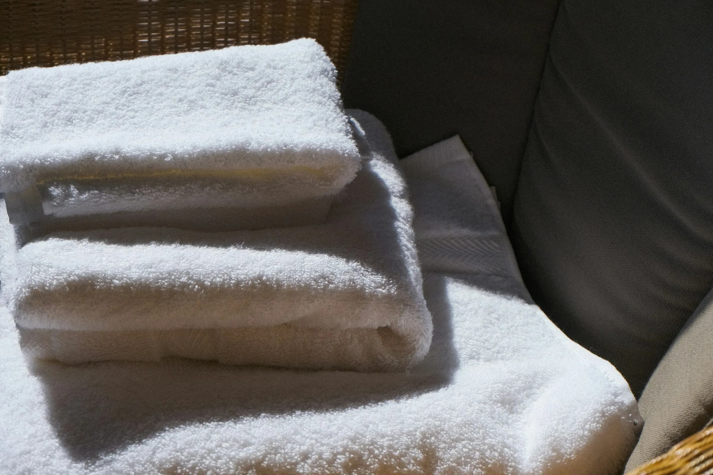 Fresh linens folded on a bed