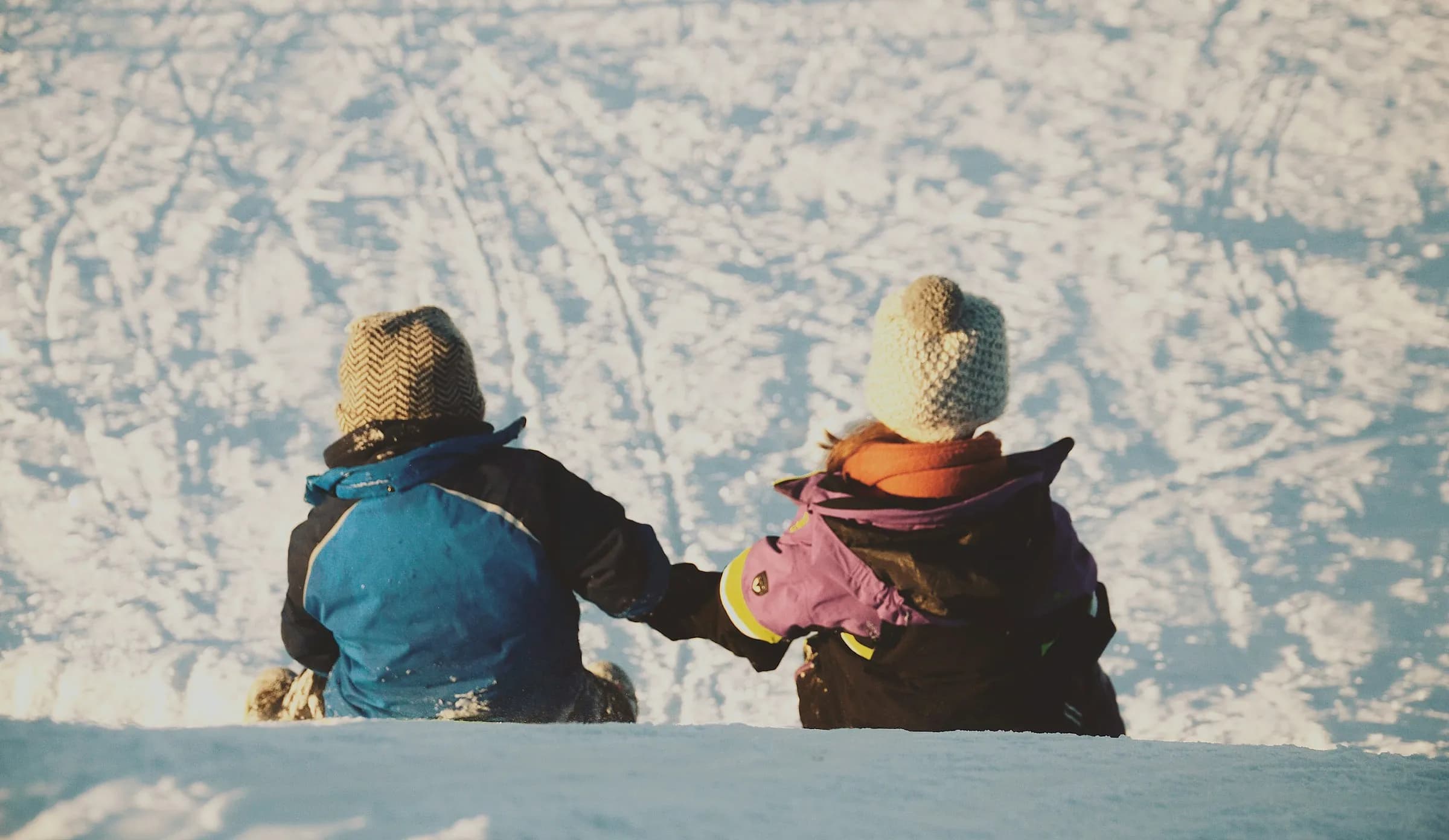 A family pulling sleds across fresh snow