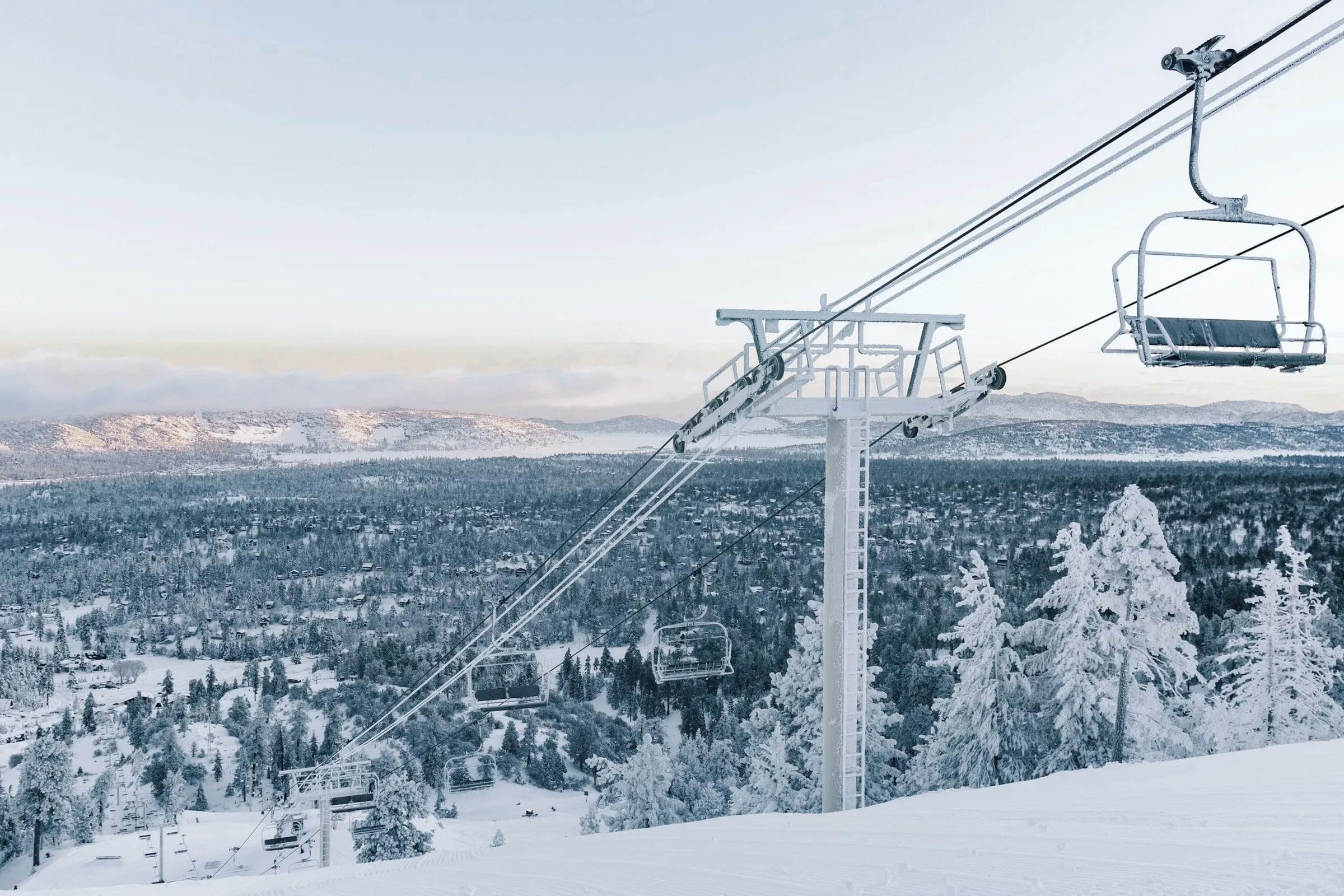 A chairlift above the valley on a clear winter morning